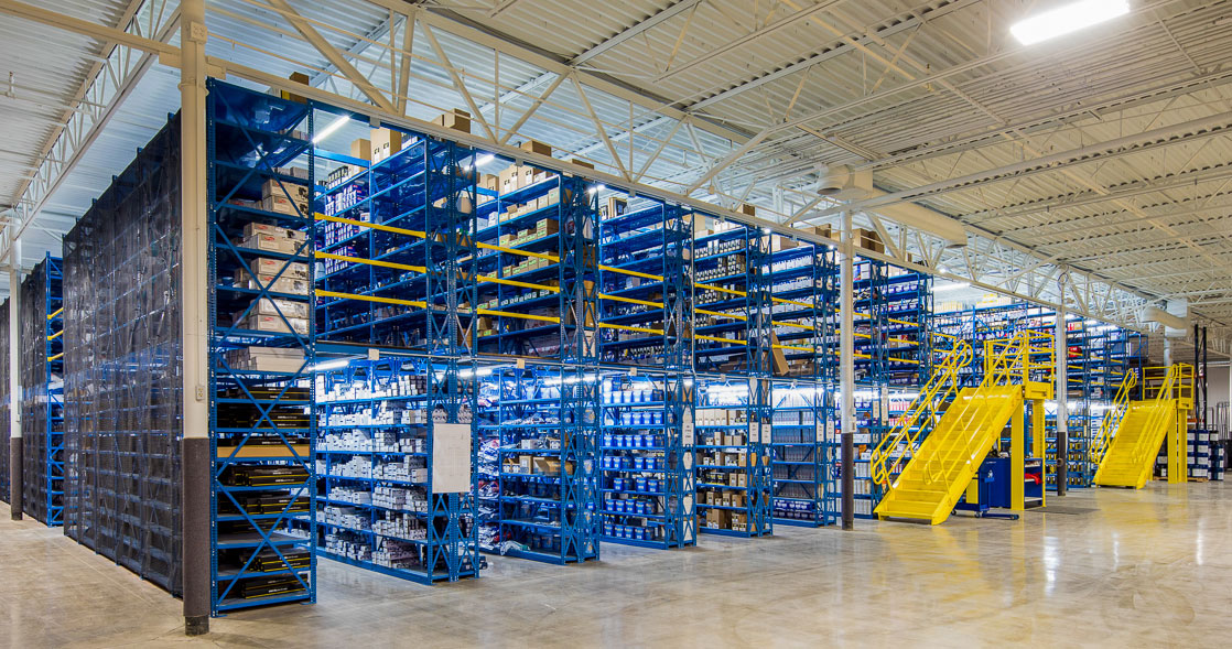 WPSS multilevel deluxe industrial open shelving high bays with catwalks blue shelving yellow stairs long aisle vew